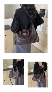 Detail of soft dark brown leather tote bag featuring a shield badge and adjustable strap