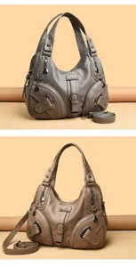 Detailed macro view showing the high-quality lychee texture and rivets on PU leather hobo bag