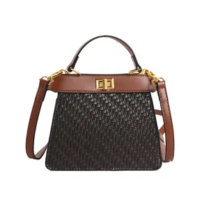Retro trapezoid tote bag in woven texture with brown leather flap and gold clasp closure