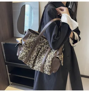 Leopard print tote bag shown on shoulder in a stylish home interior setting
