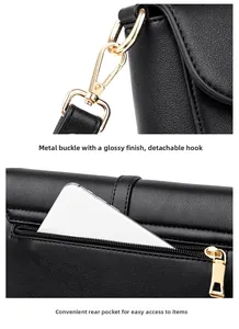 Detail of gold metal hook and back zipper pocket on black lychee grain shoulder bag