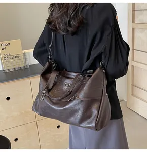 Detail of vintage dark brown tote bag in textured faux leather with shoulder strap