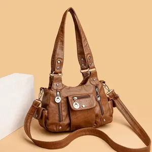 Brown soft PU leather handbag for women featuring multiple pockets and adjustable shoulder strap