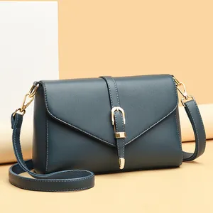 Peacock blue lychee pattern leather flap crossbody bag with gold buckle hardware
