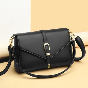 Classic black pebble leather flap shoulder bag with golden horseshoe buckle and dual straps