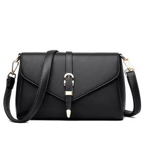 Classic black leather crossbody bag with flap cover and gold D-ring buckle detail