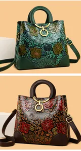 Macro detail of embossed floral leather bags with metallic hexagonal buckles and top handles