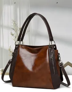Detail of vintage tote bag with glossy brown oil wax leather and metallic zippers