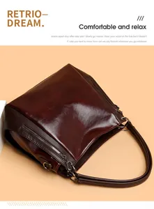 Detail of vintage burgundy faux leather tote bag with smooth texture and side pocket