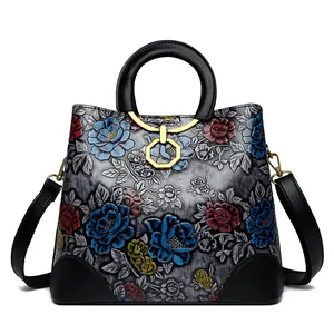 Ethnic retro gray leather handbag with embossed floral patterns and golden hardware