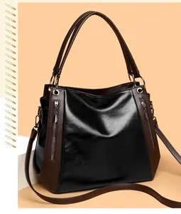 Detail of vintage soft leather tote bag with contrasting textures and metal zippers