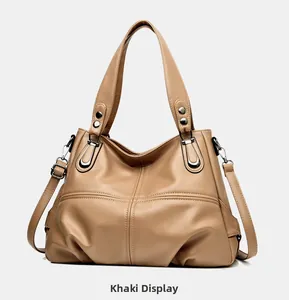 Detail view of khaki lychee grain leather tote with detachable shoulder strap and hardware