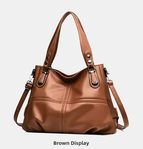 Detailed close-up of brown litchi pattern faux leather tote bag with silver hardware