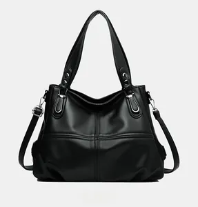 Front view of large black lychee texture tote bag with silver ring hardware and shoulder strap