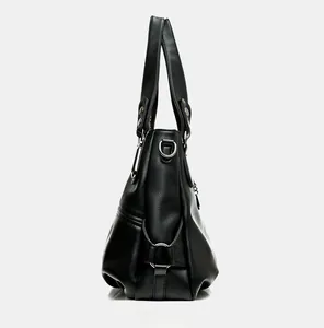 Side view of black lychee grain leather tote bag with silver D-ring hardware detail