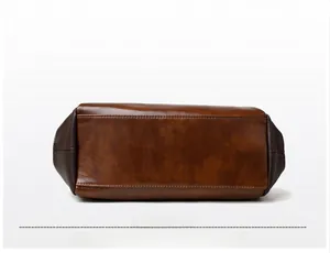 Detailed bottom view of vintage brown leather tote bag with contrast stitching
