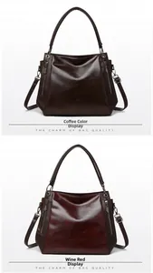 Close-up of vintage leather tote bags in coffee and wine red with metallic zipper details
