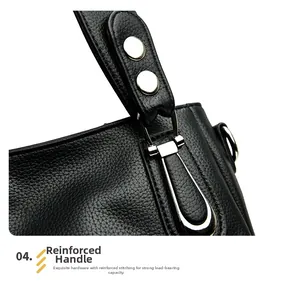 Detail of reinforced handle with polished silver hardware on black lychee grain tote bag