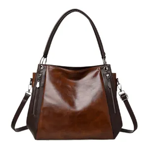 Brown vintage soft leather tote bag with two-tone design and silver zipper details