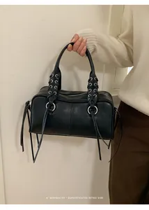 Close-up of black leather bowling bag showing silver eyelet tie-on handle details