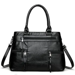 Black pebbled faux leather tote bag with three functional front zipper pockets and top handles