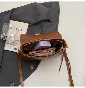 Interior view of brown leather bag showing spacious compartments and zipper pocket