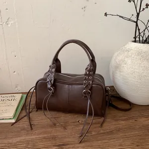 Dark brown vintage cylinder shoulder bag with silver rings and long fringe details