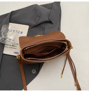 Internal view of the caramel leather bag showing main compartment and zippered pocket