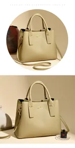 Close-up of beige lychee grain leather bucket bag with gold kangaroo logo and round handles