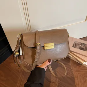 Retro brown leather crossbody bag with gold rectangular clasp and elegant tassel detail