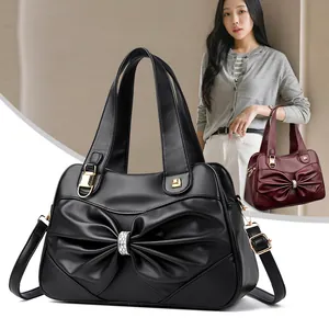 Elegant black faux leather handbag with large bow and rhinestones in high quality texture