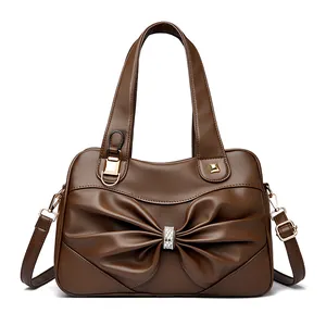 Elegant dark brown pebble leather handbag with rhinestone bow detail and shoulder strap