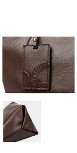 Detail of dark brown leather tote bag showing textured logo tag and precise stitching