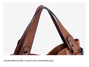 Close-up of caramel leather handbag showing detailed stitching and metal rivet reinforcement