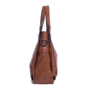 Side view of vintage brown tote bag with pebbled leather texture and metal D-ring detail