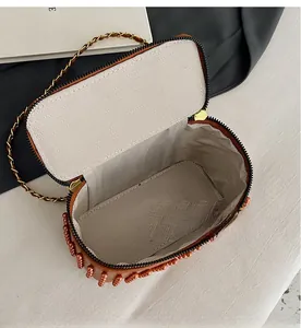 Deep interior view of box bag featuring herringbone fabric lining and dual zipper design