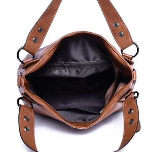 Interior view of brown tote bag showing main compartment and functional inner pockets