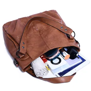 Interior detail of large brown tote bag showing capacity for iPad and daily essentials