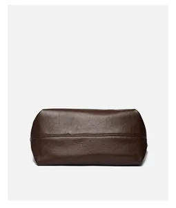 Detailed side view of deep brown tote bag with textured faux leather and stitching