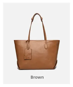 Detailed view of brown soft leather tote bag showing textured finish and embossed tag