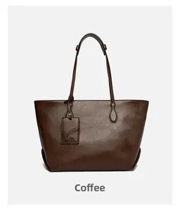 Close-up of coffee brown tote bag showing natural leather texture and square tag detail