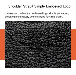 Detalle del logotipo en relieve en bolso de cuero granulado negro con textura fina