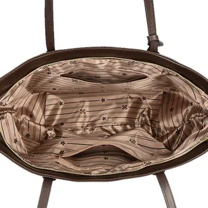 Top view of spacious interior with striped lining and gold zipper on brown leather tote bag