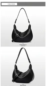 Detalle del bolso de media luna negro con textura de cuero granulado y hebilla metal