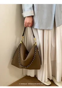 Brown soft leather tote bag with chain strap shown in a retro minimalist lifestyle scene