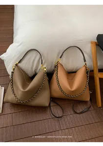 Detail of soft pebbled leather hobo bags with decorative gold chain and adjustable strap