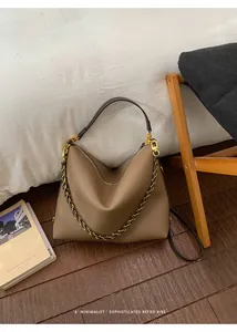 Detailed macro of brown lychee grain leather tote with golden chain and zipper closure