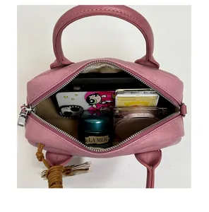 Macro view of dusty rose Boston bag interior showing spacious storage for cosmetics