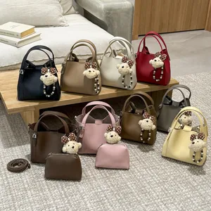 Vintage-style bucket bag set with plush bear pendant and adjustable shoulder strap