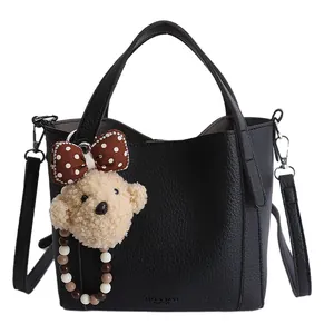 Classic black litchi pattern leather bucket bag with cute bear charm and long strap